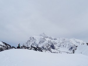 Lee traversing a knoll with Shuksan in the background