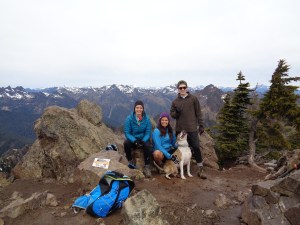 Three hikers and a happy dog (true summit)