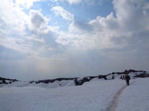 Blue sky just above the crater, hail held at bay