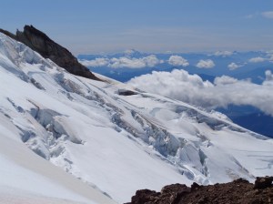 Glacier Peak beyond crevasses on the Deming glacier