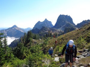 Looking back at everyone approaching the talus field, Townsend and Merchant in the background
